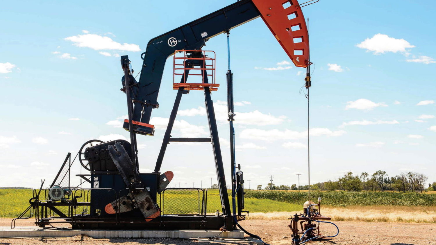 IJACK DGAS hydraulic pumping unit and gas compressor working on the Lodgepole oil wells